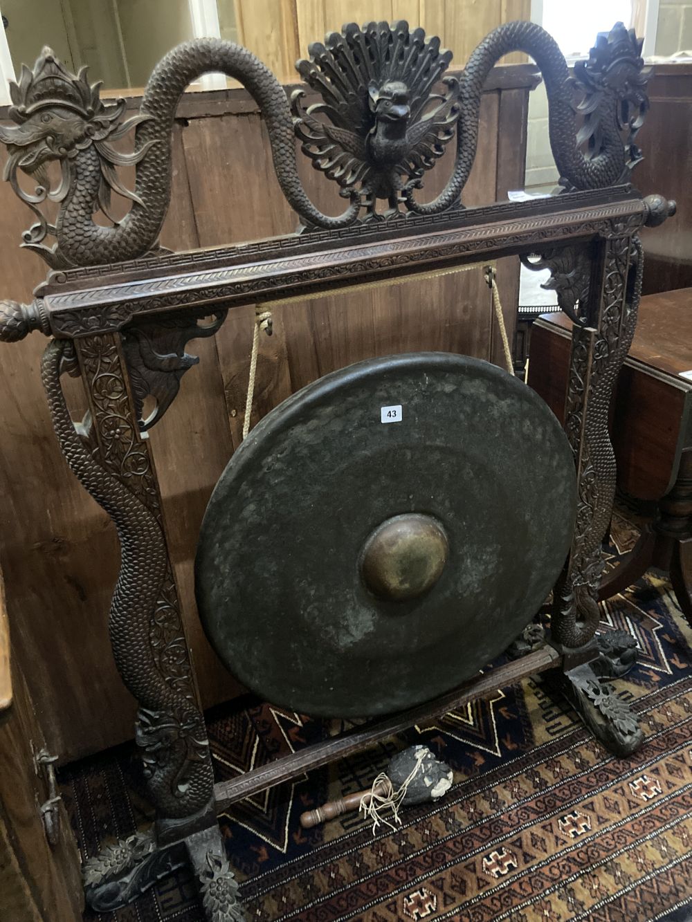 A Burmese hardwood dinner gong, width 104cm height 125cm